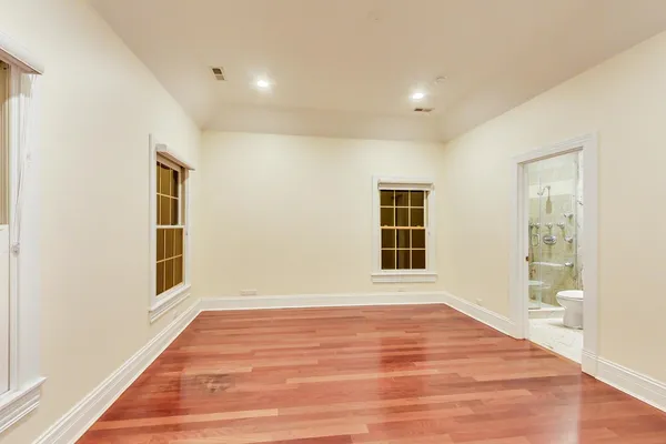 a view of empty room with kitchen