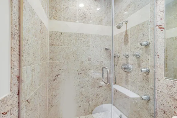 a bathroom with a granite countertop bathtub shower sink and vanity