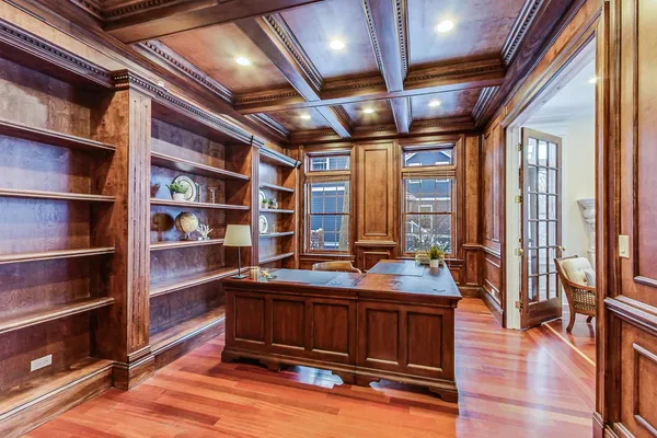 a room with a table chairs and wooden floors