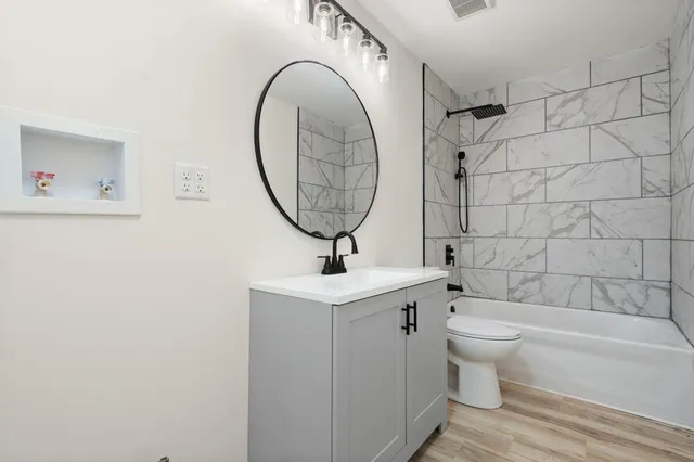 a bathroom with a toilet a sink and bathtub