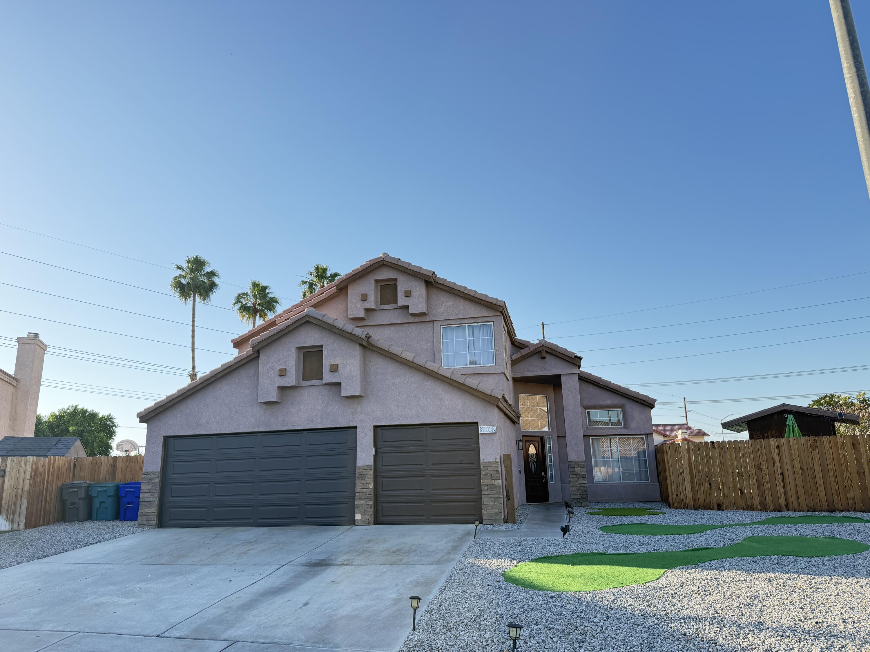81032 Red Bluff Road Indio, CA 92201 - Photo 33 of 33 a front view of a house with a yard and garage