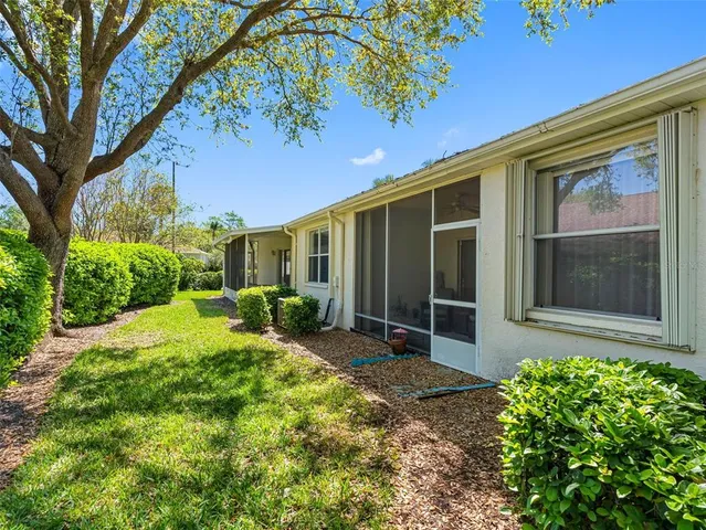 a view of a house with backyard and a garden