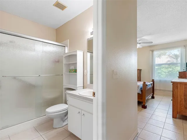 a bathroom with a toilet a sink and shower