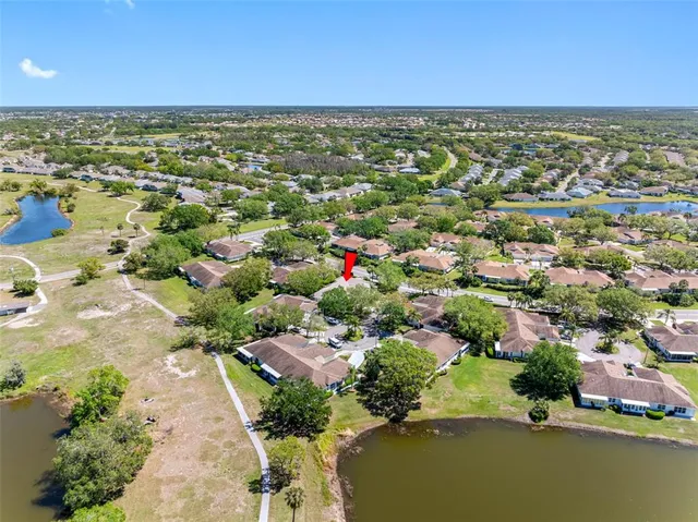 an aerial view of residential houses with outdoor space and river