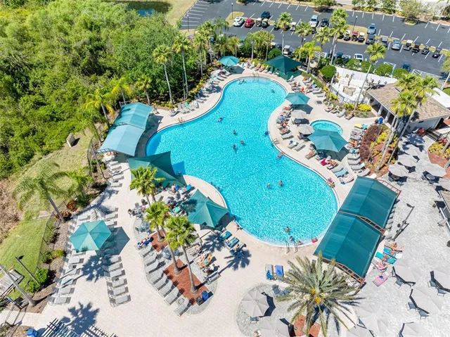 an aerial view of residential houses with outdoor space and river