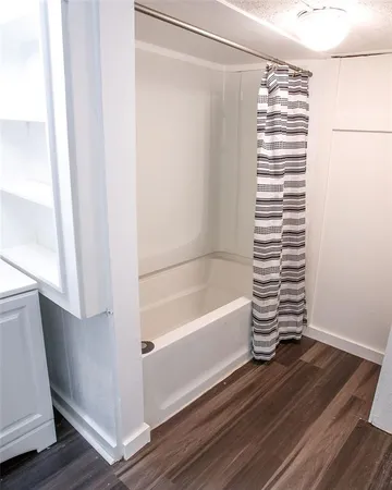 a bathroom with a bathtub and a window