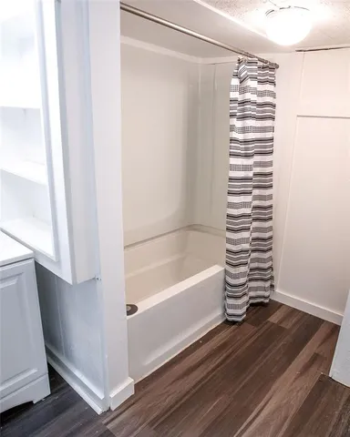 a bathroom with a bathtub and a window