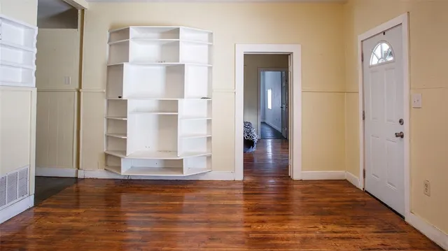 a view of a room with wooden floor and staircase