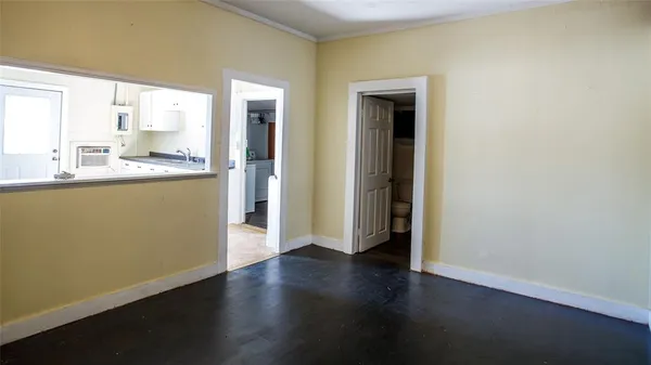 a view of a kitchen with wooden floor and a window