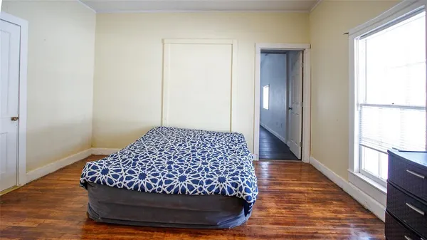 a bedroom with a bed and a window