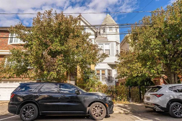 a front view of a house with parking space