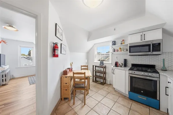 a kitchen with stainless steel appliances a stove a sink cabinets and a refrigerator