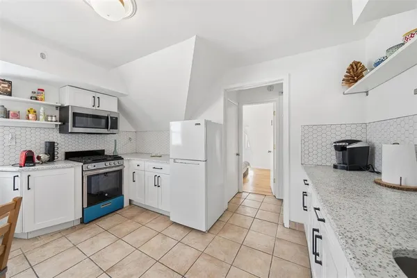 a kitchen with granite countertop cabinets and steel stainless steel appliances