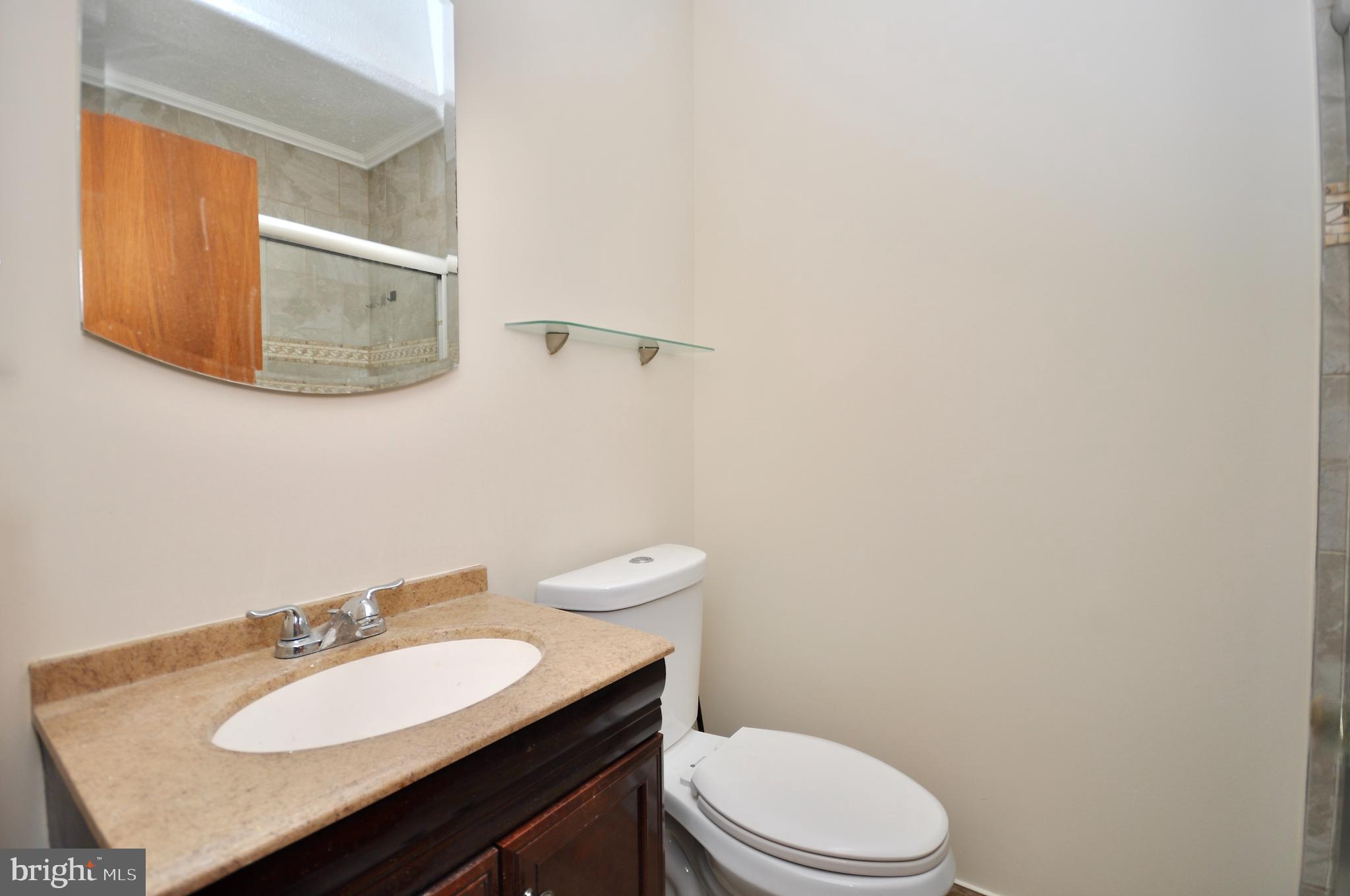 2216 Emerson Street Philadelphia, PA 19152 - Photo 11 of 31 a bathroom with a sink a toilet and mirror