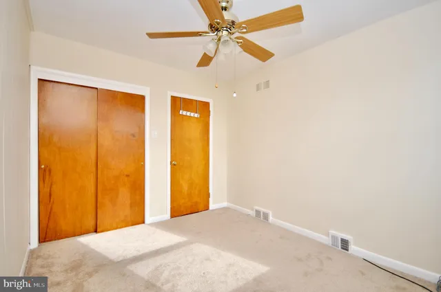 a view of a room with a ceiling fan