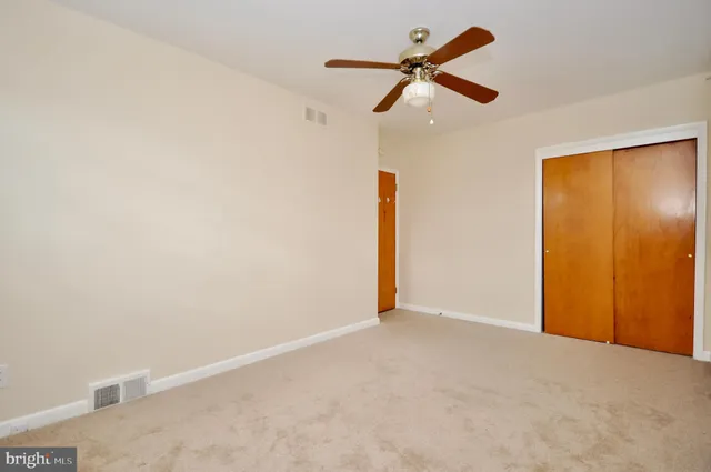 a view of a room with a ceiling fan