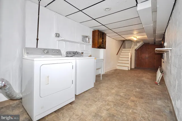 a view of storage and utility room with washer and dryer