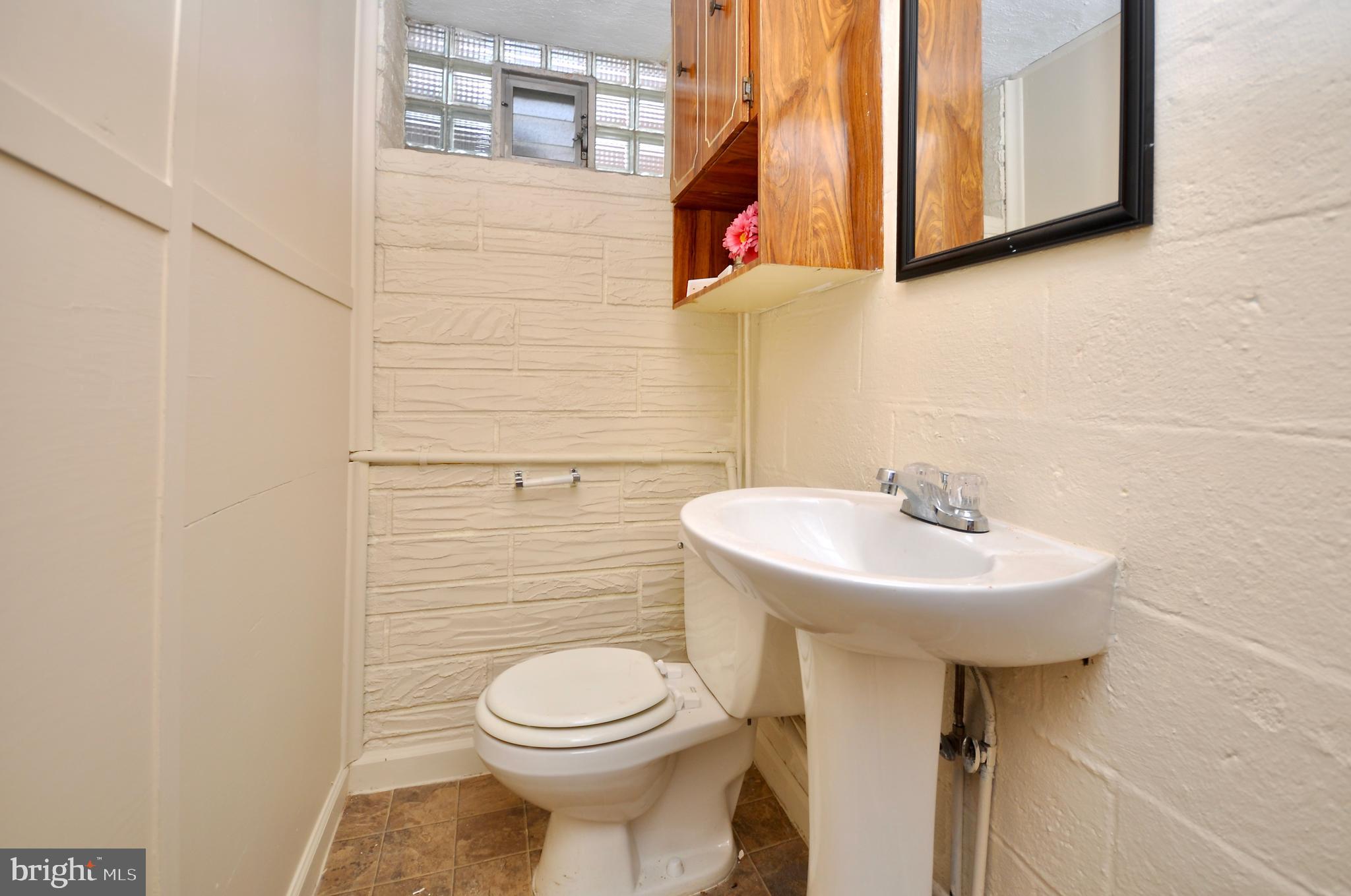 2216 Emerson Street Philadelphia, PA 19152 - Photo 26 of 31 a bathroom with a sink a toilet and mirror