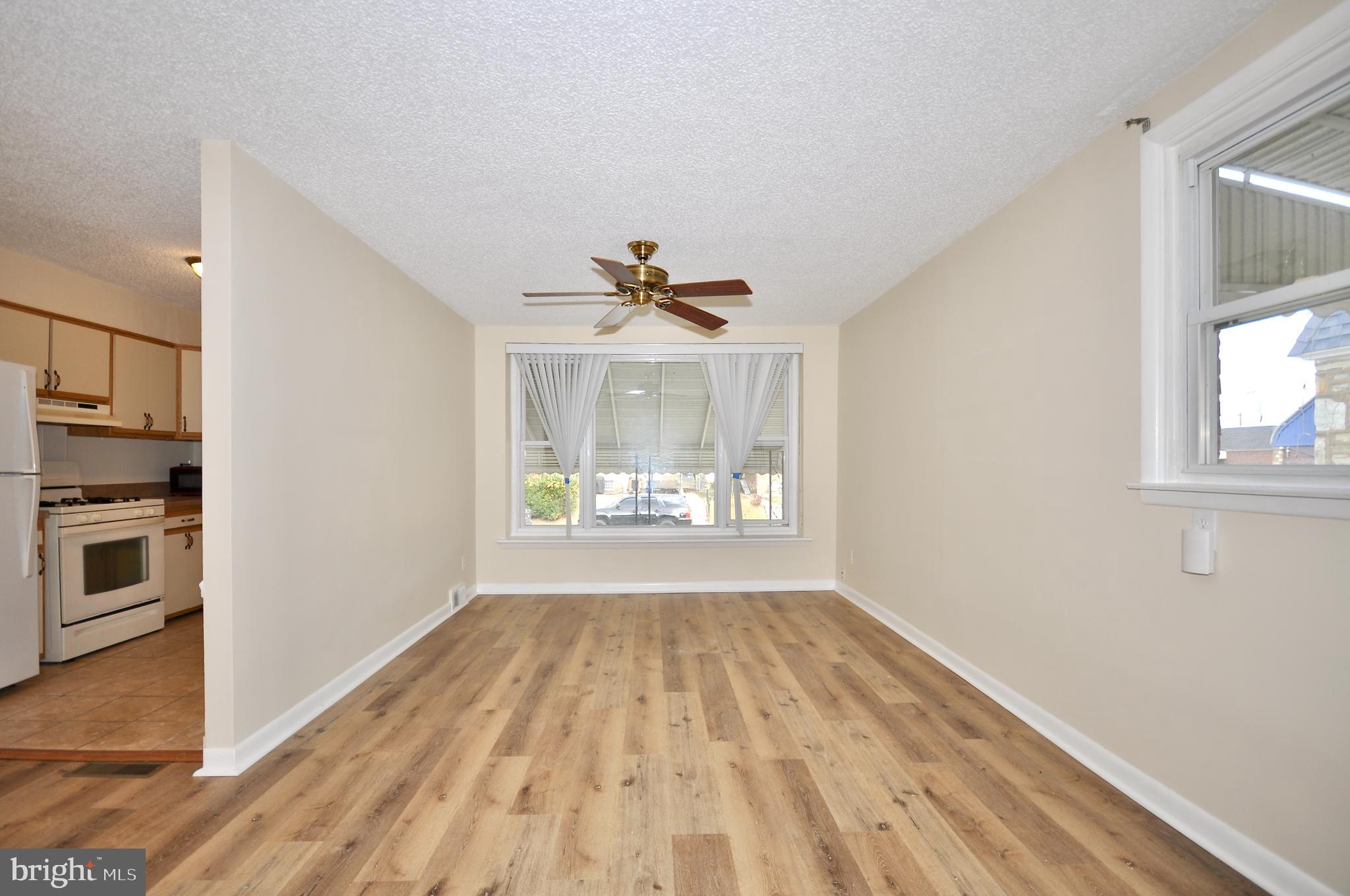 2216 Emerson Street Philadelphia, PA 19152 - Photo 6 of 31 a view of an empty room with a window and wooden floor