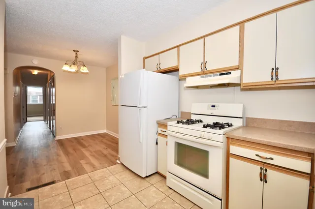a kitchen with a stove and a refrigerator