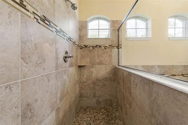 a bedroom with two beds and a large window