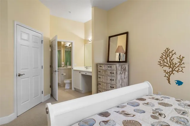 an aerial view of ocean and residential houses with outdoor space