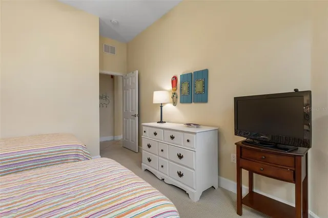 a front view of a house with a yard and potted plants