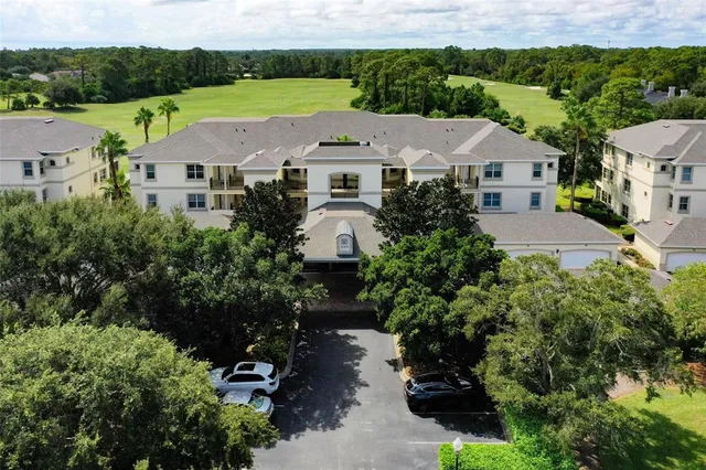 a view of a wooden door with a bench and trees