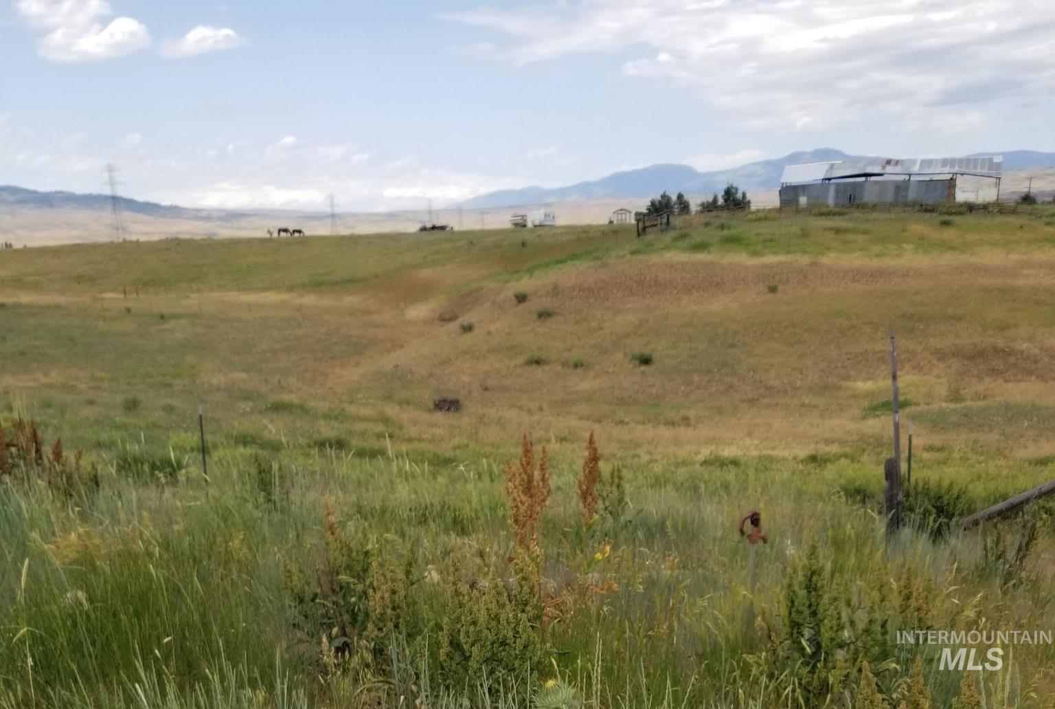 View of mountain backdrop featuring rural landscape and a pastoral area