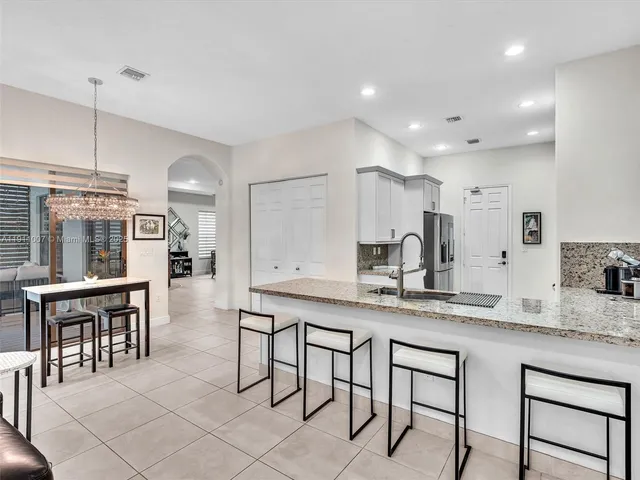 a kitchen with granite countertop cabinets table and chairs