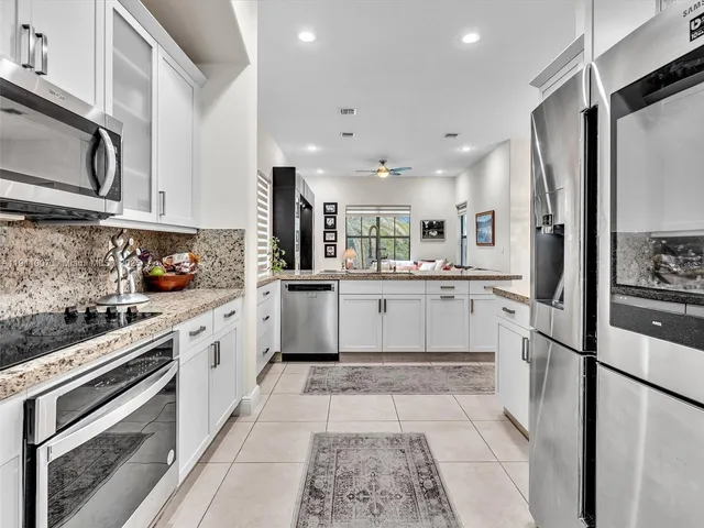 a kitchen with a sink stainless steel appliances and cabinets