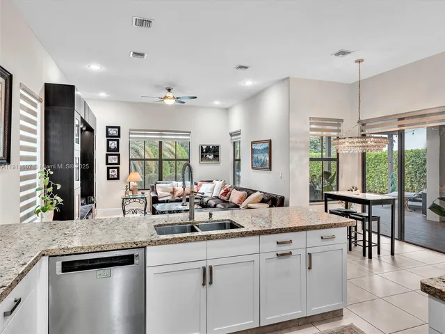 a kitchen with counter top space a sink cabinets and appliances