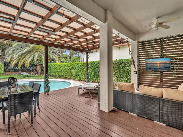 a view of a patio with table and chairs and wooden floor