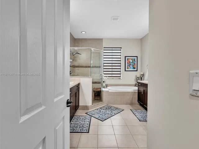 a kitchen with a refrigerator and a stove top oven