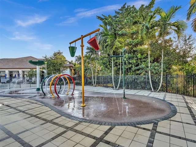 a view of a park with iron fence