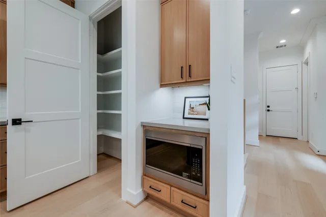 a dining room with furniture and kitchen view