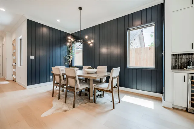 a living room with furniture kitchen view and a large mirror