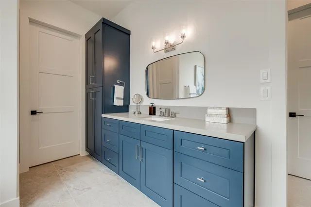 a bathroom with a tub a sink and mirror