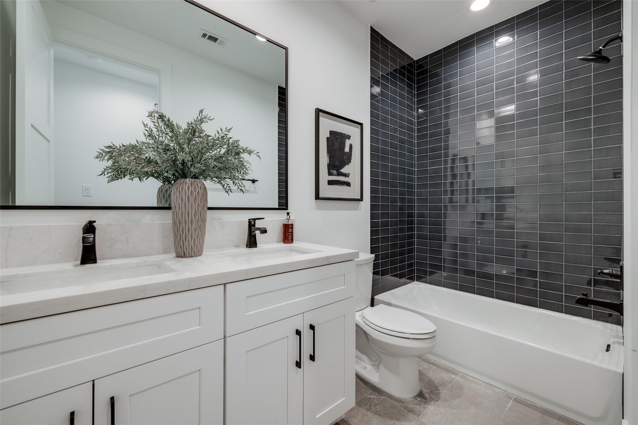 2327 Richton Street Houston, TX 77098 - Photo 40 of 47 a bathroom with a sink a toilet a mirror a vanity and shower