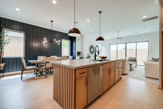 a very nice looking dining room with a large window and stainless steel appliances