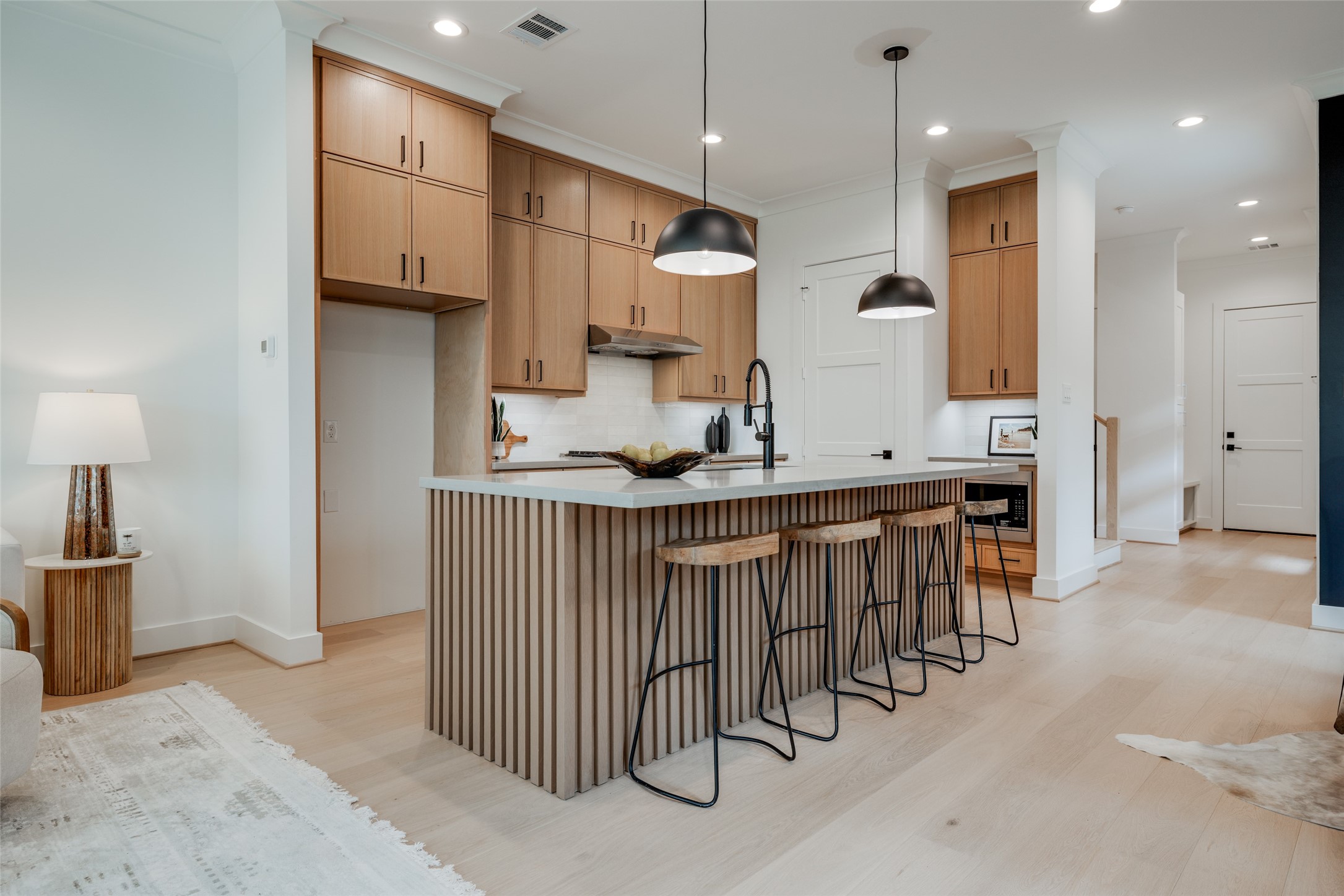 2327 Richton Street Houston, TX 77098 - Photo 12 of 47 a kitchen with stainless steel appliances kitchen island granite countertop a table chairs sink and cabinets