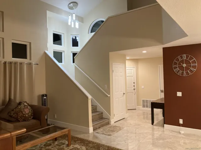 a living room with stairs and furniture