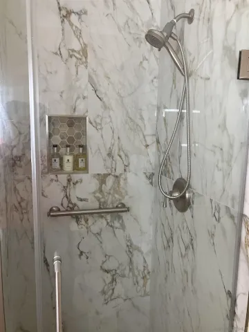 a bathroom with a tub a double vanity sink and mirror