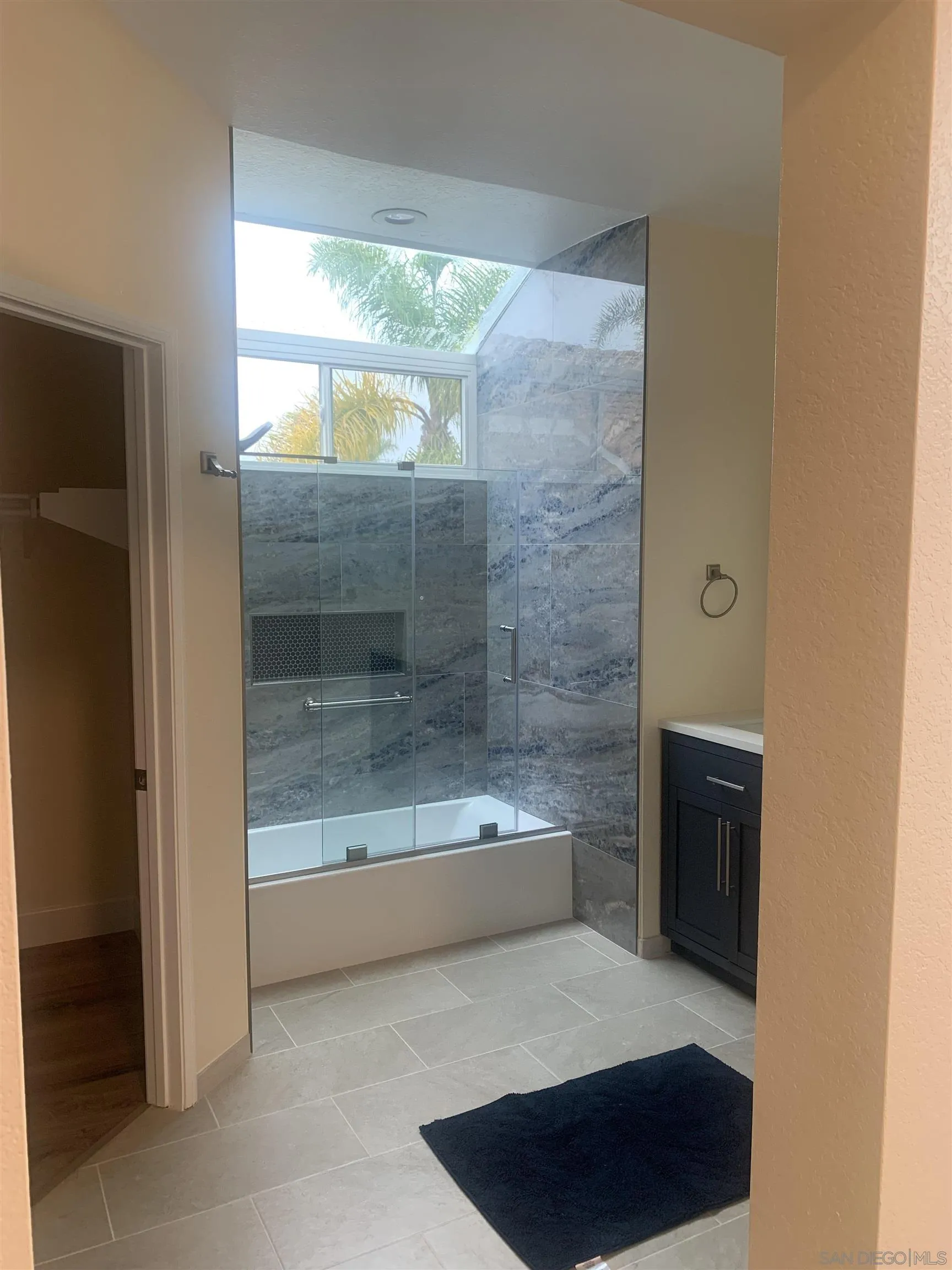 8418 Hovenweep Court San Diego, CA 92129 - Photo 25 of 29 a bathroom with a bathtub and a shower