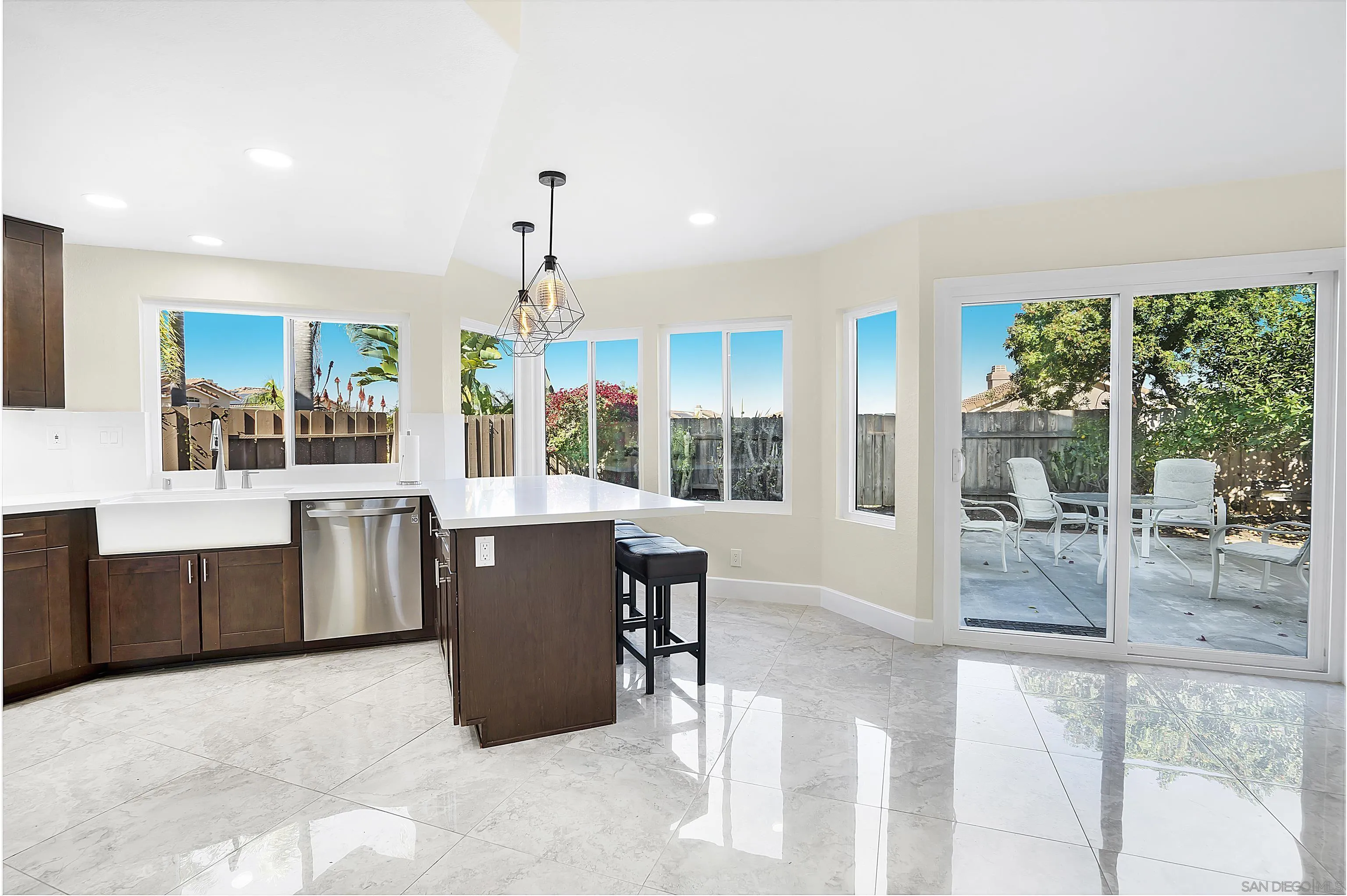 8418 Hovenweep Court San Diego, CA 92129 - Photo 3 of 29 a view of a dining room with furniture large windows and wooden floor