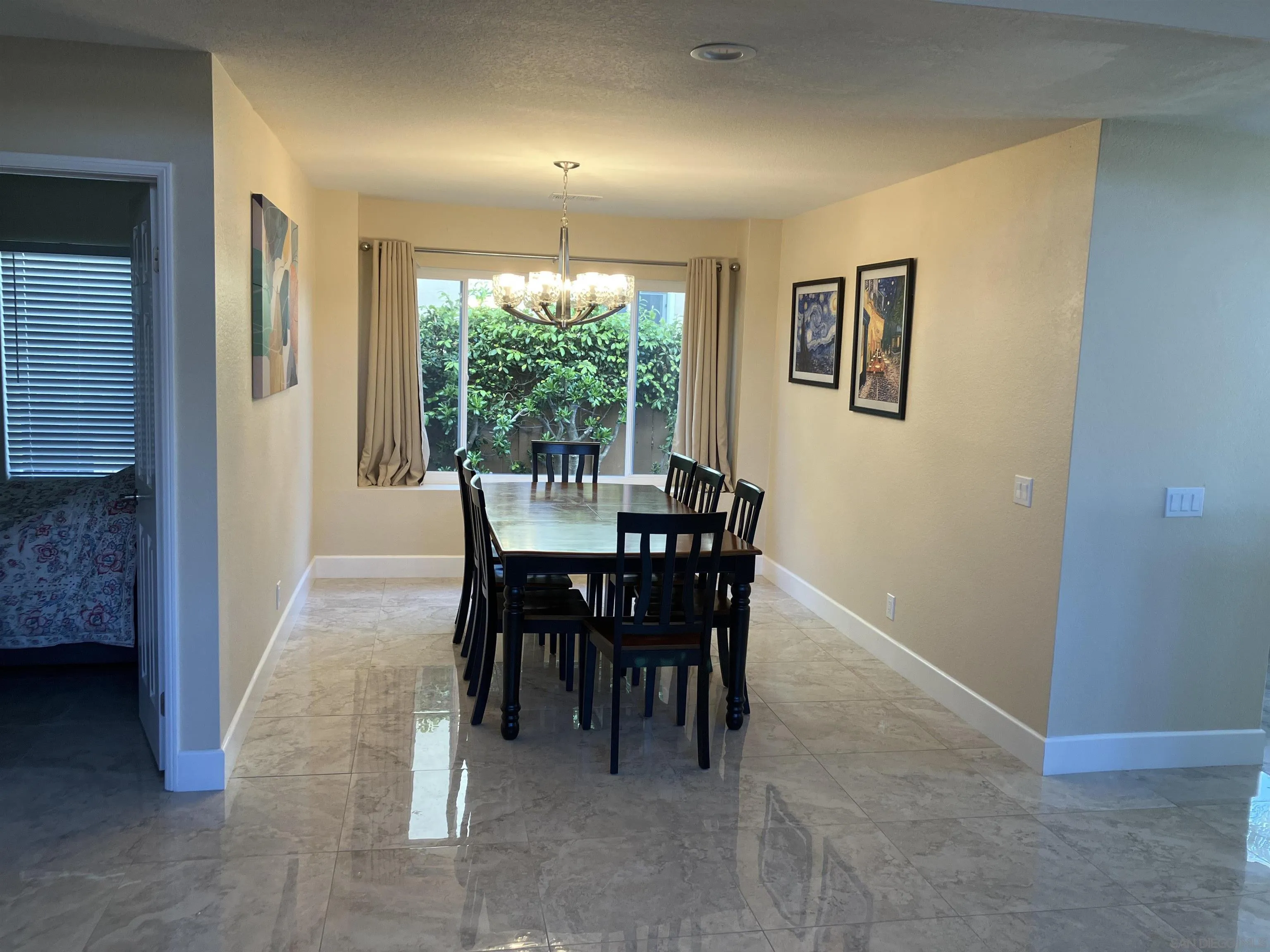 8418 Hovenweep Court San Diego, CA 92129 - Photo 9 of 29 a view of a dining room with furniture and a potted plant