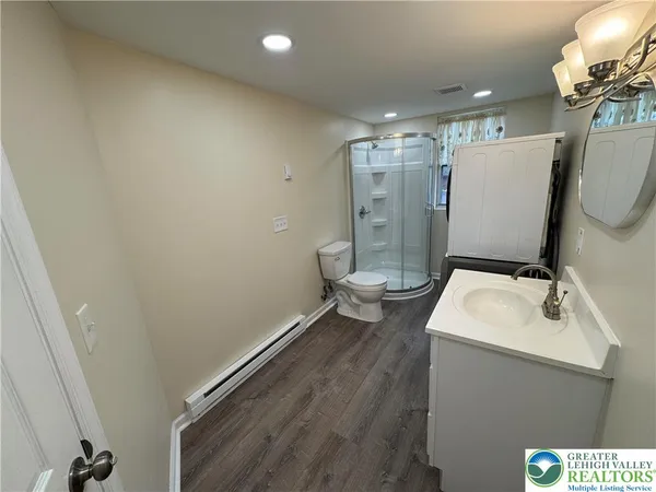 a bathroom with a sink mirror vanity and toilet
