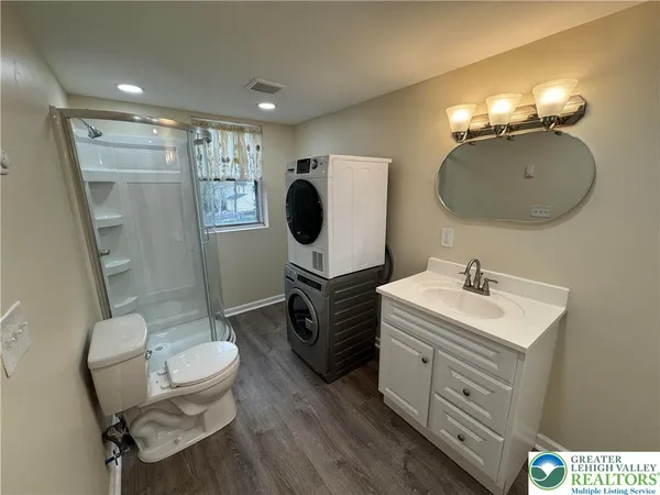 a bathroom with a sink mirror and vanity