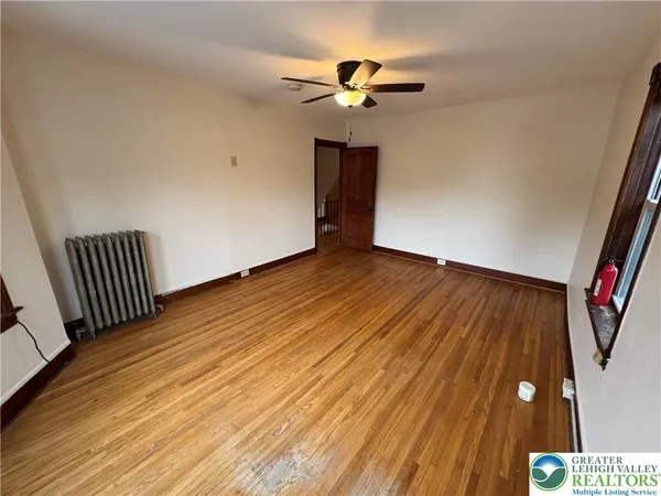 wooden floor in an empty room with a window