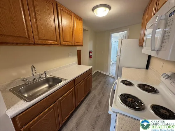 a kitchen with a sink a stove and cabinets
